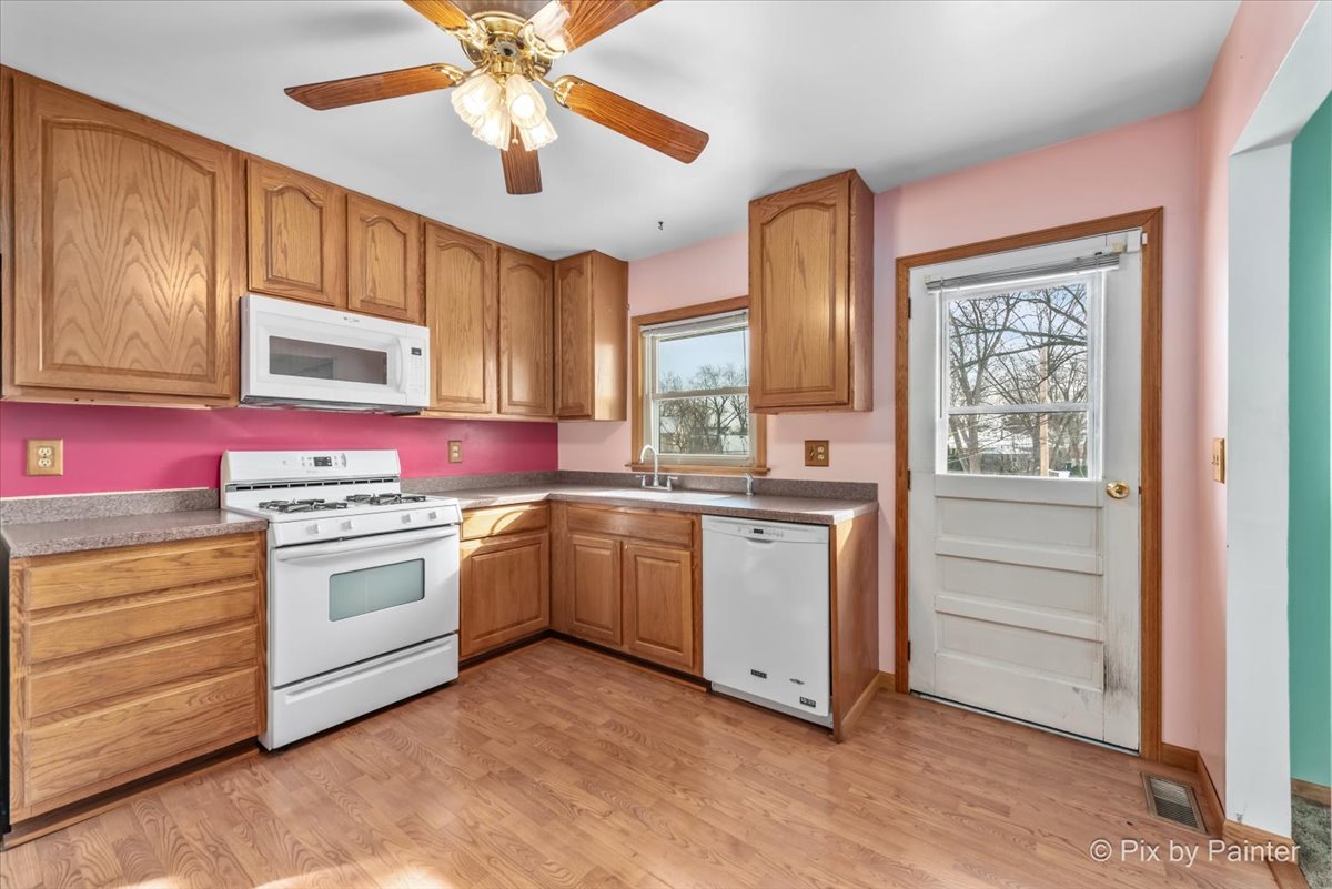 411 Krause Avenue Streamwood, IL 60107 - Photo 13 of 54 a kitchen with granite countertop cabinets stainless steel appliances and a window
