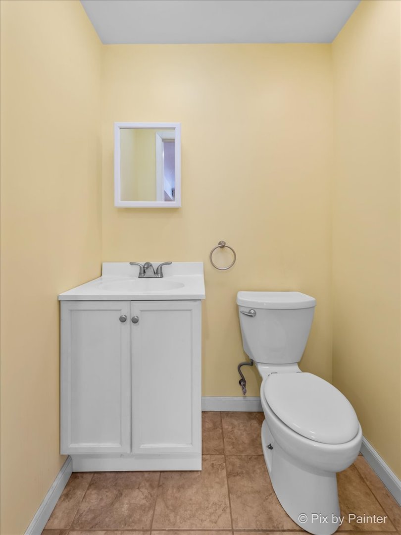 411 Krause Avenue Streamwood, IL 60107 - Photo 29 of 54 a bathroom with a sink a toilet and vanity