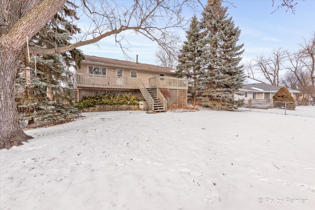 411 Krause Avenue Streamwood, IL 60107 - Photo 33 of 54 a view of a white house with a snow on the road
