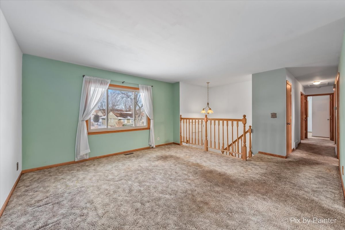411 Krause Avenue Streamwood, IL 60107 - Photo 6 of 54 a view of an empty room with a window