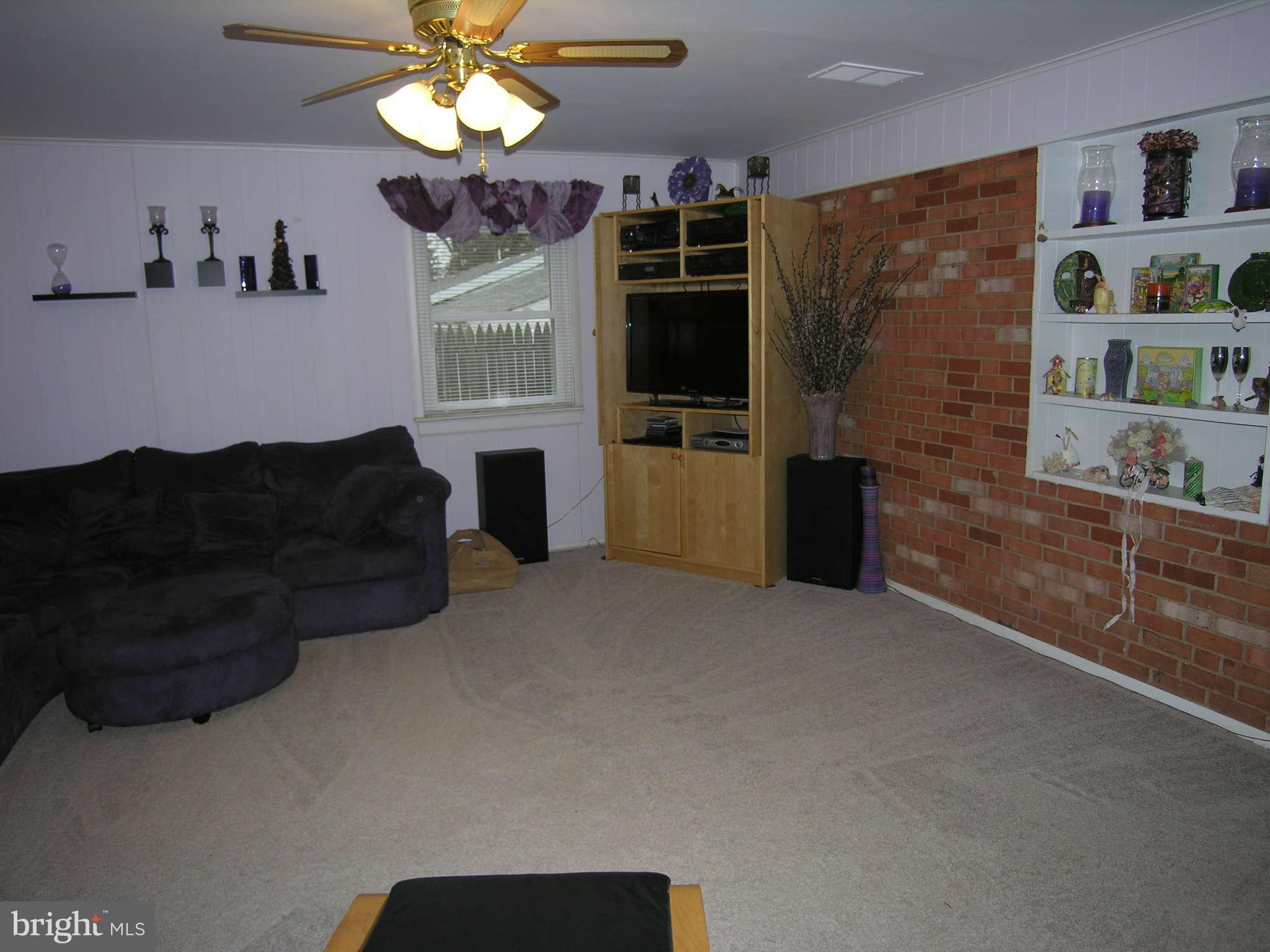 4111 Lees Corner Road Chantilly, VA 20151 - Photo 12 of 19 a living room with furniture a flat screen tv and a wall paintings