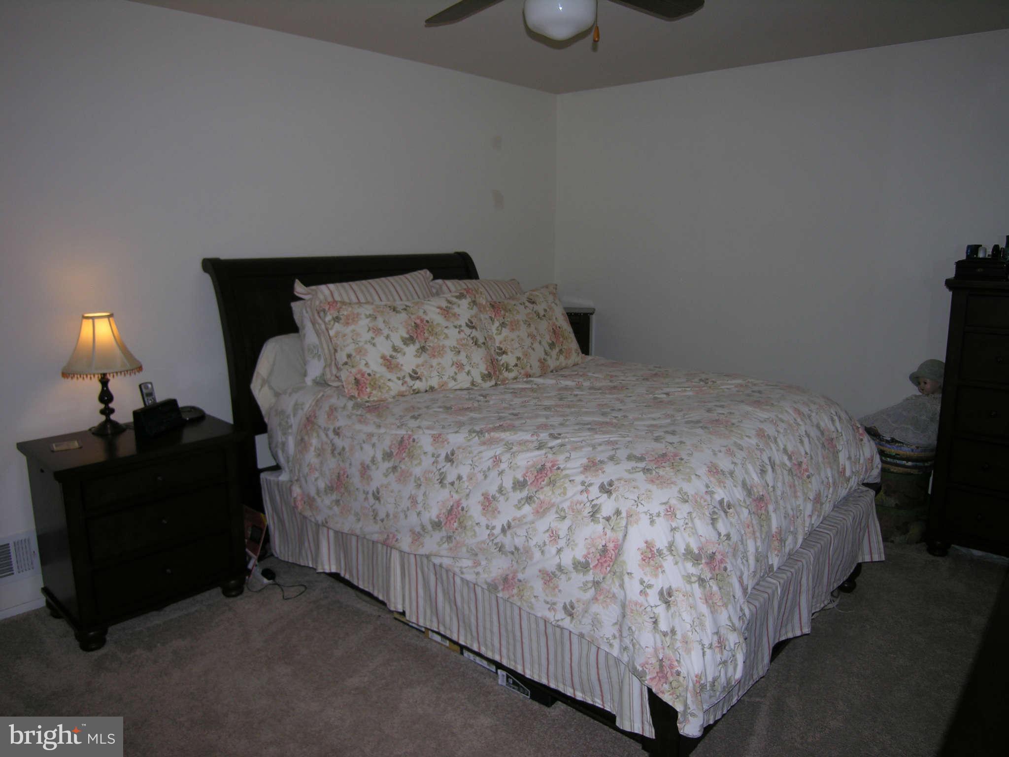 4111 Lees Corner Road Chantilly, VA 20151 - Photo 14 of 19 a bed sitting in a bedroom and lamp with wooden floor