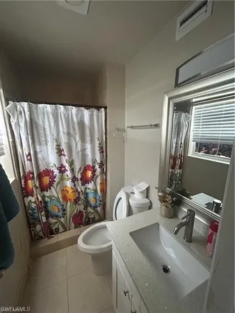 a bathroom with a sink mirror and vanity