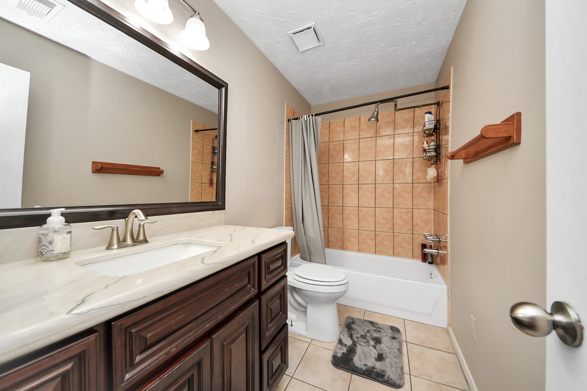 9634 Thistle Trail Drive Houston, TX 77070 - Photo 14 of 22 a bathroom with a granite countertop sink mirror vanity and toilet