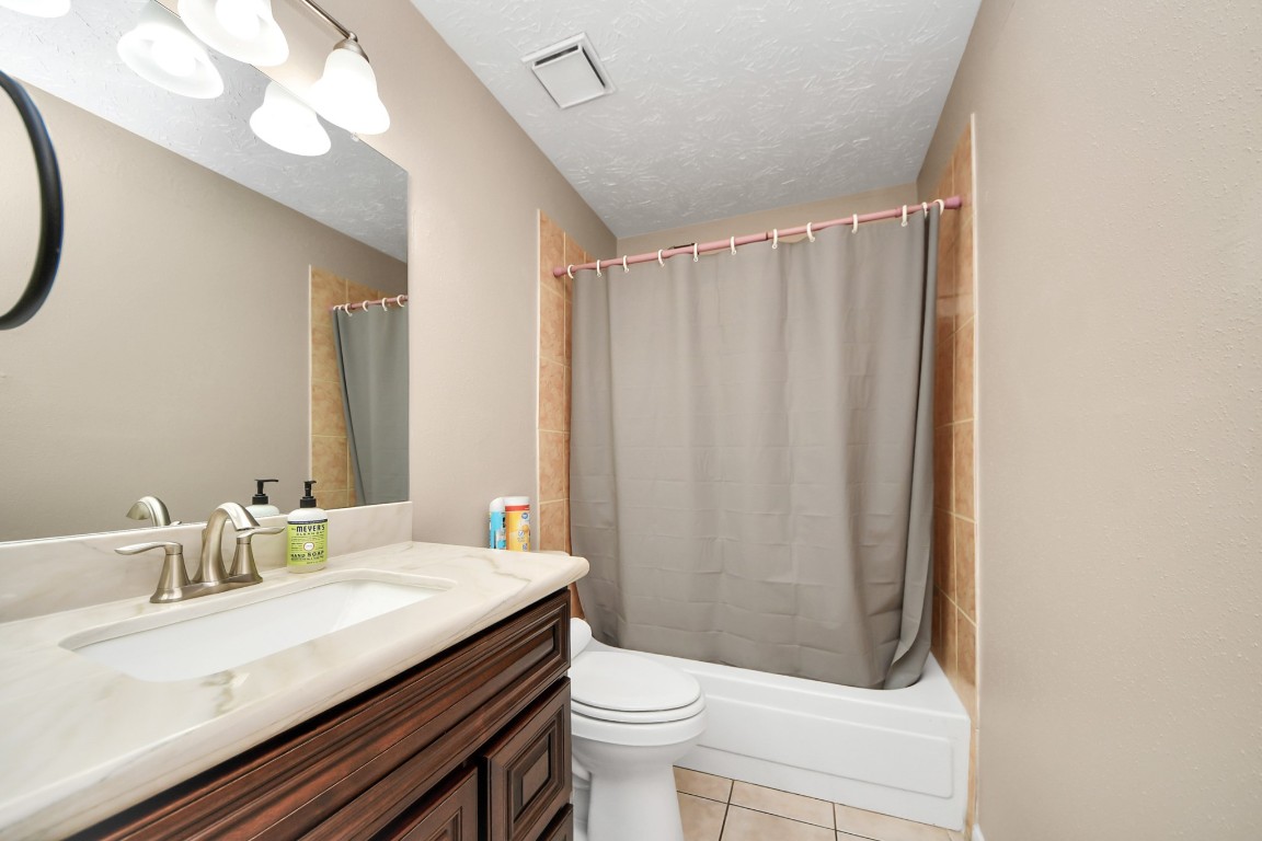 9634 Thistle Trail Drive Houston, TX 77070 - Photo 17 of 22 a bathroom with a granite countertop sink toilet and a mirror