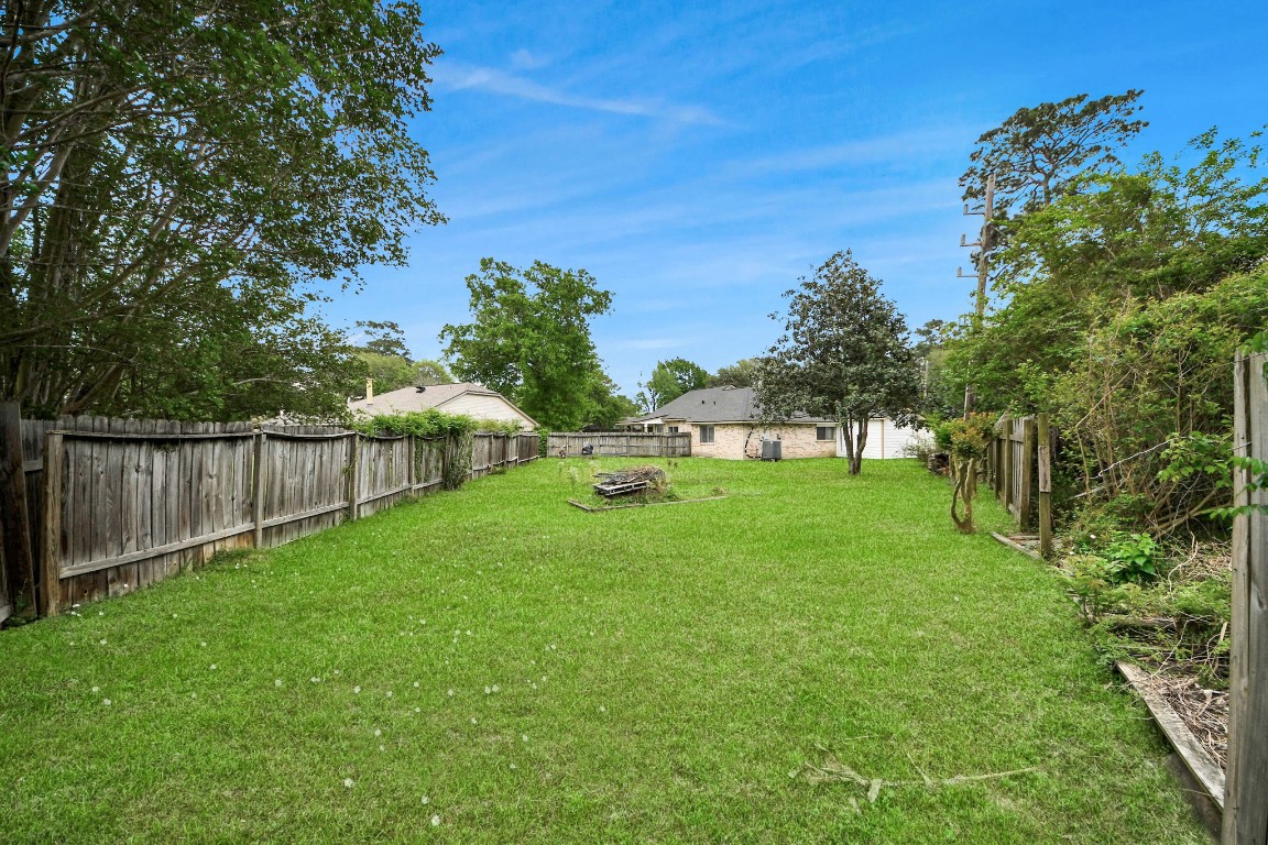 9634 Thistle Trail Drive Houston, TX 77070 - Photo 21 of 22 a green field with lots of trees in it