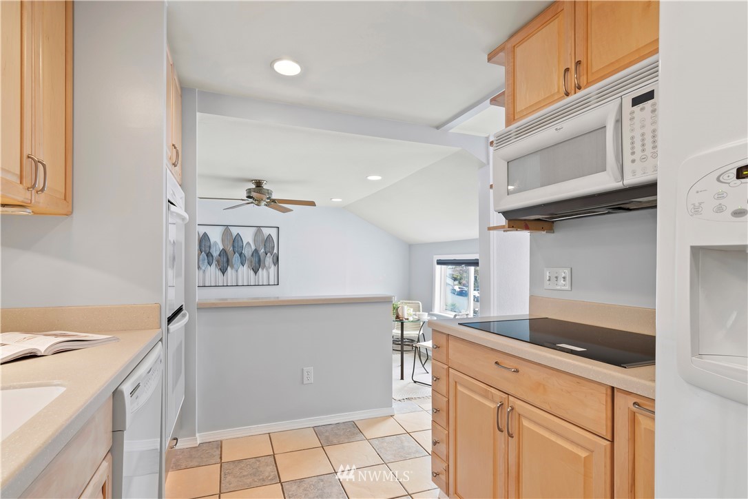 554 Bronson Way Northeast Renton, WA 98056 - Photo 15 of 35 a kitchen with stainless steel appliances granite countertop a sink and a stove