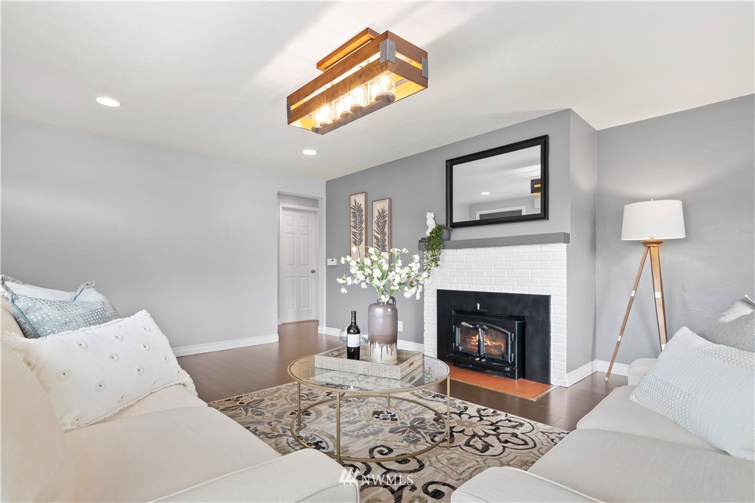 554 Bronson Way Northeast Renton, WA 98056 - Photo 5 of 35 a living room with furniture a window and a fireplace