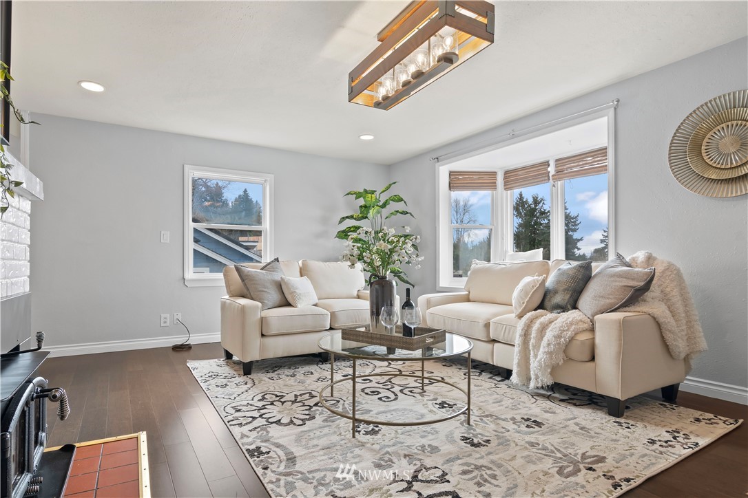 554 Bronson Way Northeast Renton, WA 98056 - Photo 8 of 35 a living room with furniture a bed and a chandelier