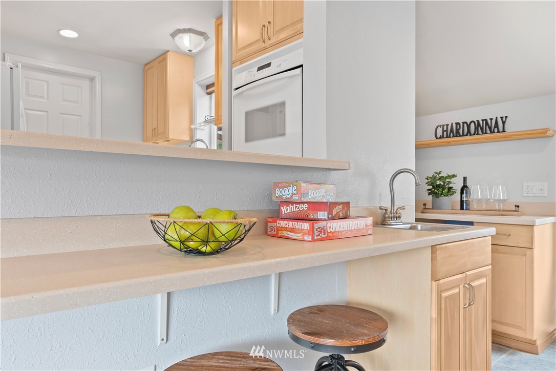 554 Bronson Way Northeast Renton, WA 98056 - Photo 10 of 35 a kitchen with a sink a stove and cabinets