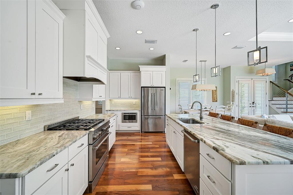 830 Tarawitt Drive Longboat Key, FL 34228 - Photo 11 of 74 a kitchen with stainless steel appliances granite countertop a sink a stove and a refrigerator