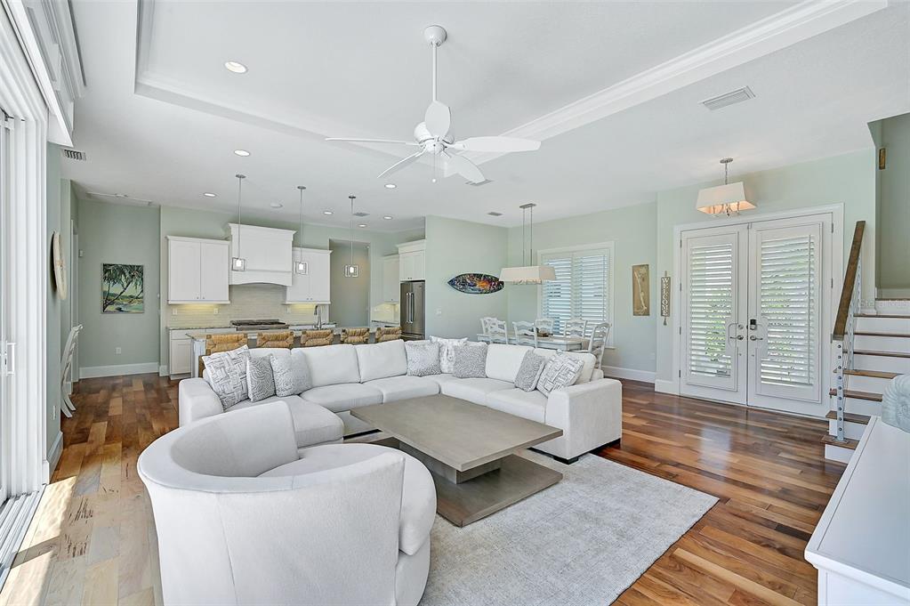 830 Tarawitt Drive Longboat Key, FL 34228 - Photo 16 of 74 a living room with furniture and wooden floor