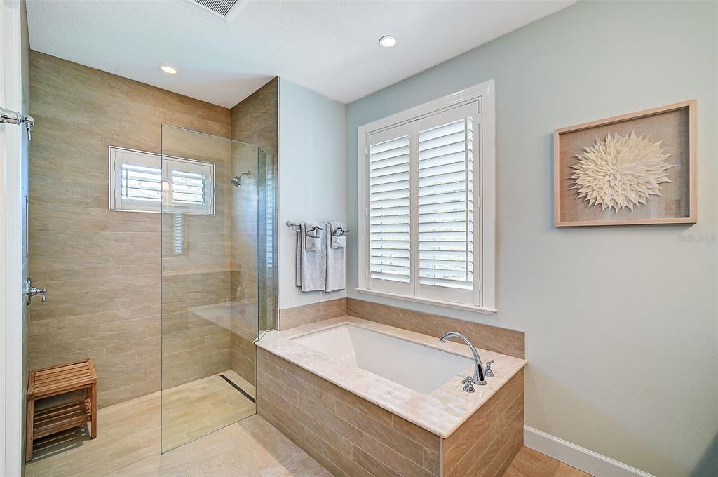 830 Tarawitt Drive Longboat Key, FL 34228 - Photo 25 of 74 a bath room with a bath tub and a shower