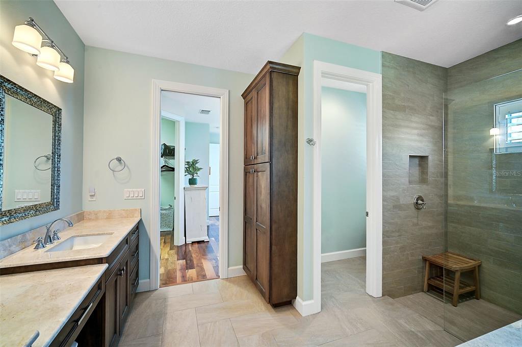 830 Tarawitt Drive Longboat Key, FL 34228 - Photo 26 of 74 a spacious bathroom with a double vanity sink toilet and shower