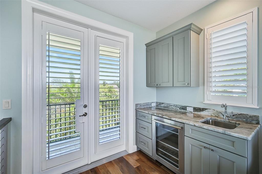 830 Tarawitt Drive Longboat Key, FL 34228 - Photo 29 of 74 a kitchen with stainless steel appliances granite countertop a sink and a microwave