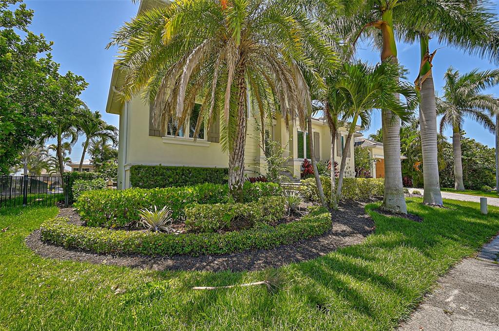 830 Tarawitt Drive Longboat Key, FL 34228 - Photo 3 of 74 a view of a garden with a palm trees