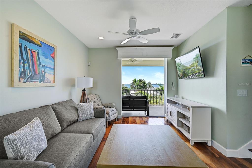 830 Tarawitt Drive Longboat Key, FL 34228 - Photo 33 of 74 a living room with furniture and a flat screen tv
