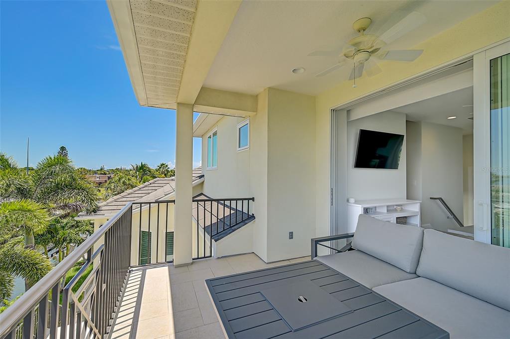 830 Tarawitt Drive Longboat Key, FL 34228 - Photo 39 of 74 a view of a balcony with wooden floor and stairs