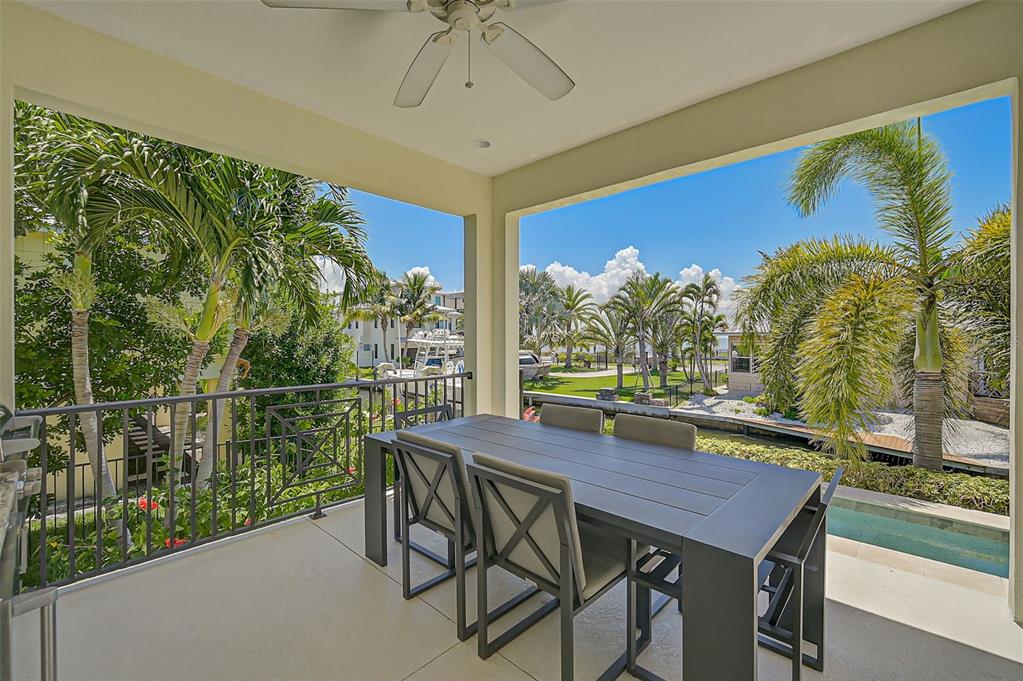 830 Tarawitt Drive Longboat Key, FL 34228 - Photo 44 of 74 a view of a dining table and chairs in the balcony