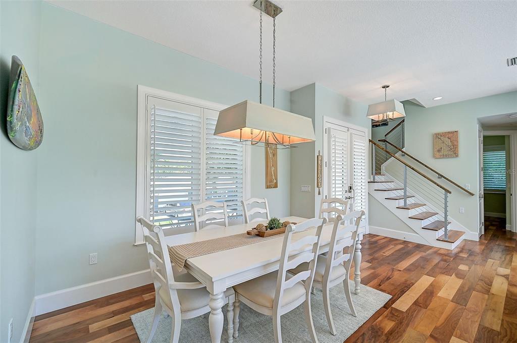830 Tarawitt Drive Longboat Key, FL 34228 - Photo 6 of 74 a view of a dining room with furniture and wooden floor