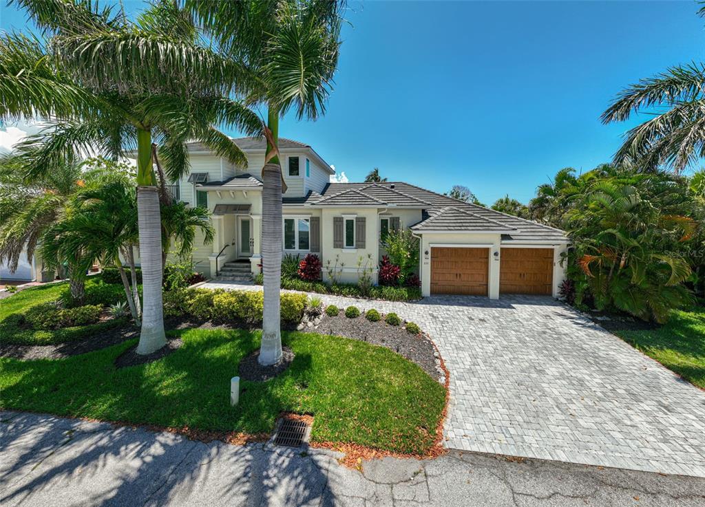 830 Tarawitt Drive Longboat Key, FL 34228 - Photo 69 of 74 a front view of a house with garden