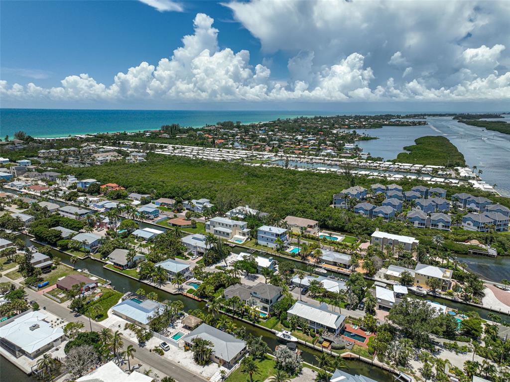 830 Tarawitt Drive Longboat Key, FL 34228 - Photo 70 of 74 a view of a city with lots of residential buildings ocean and mountain view in back