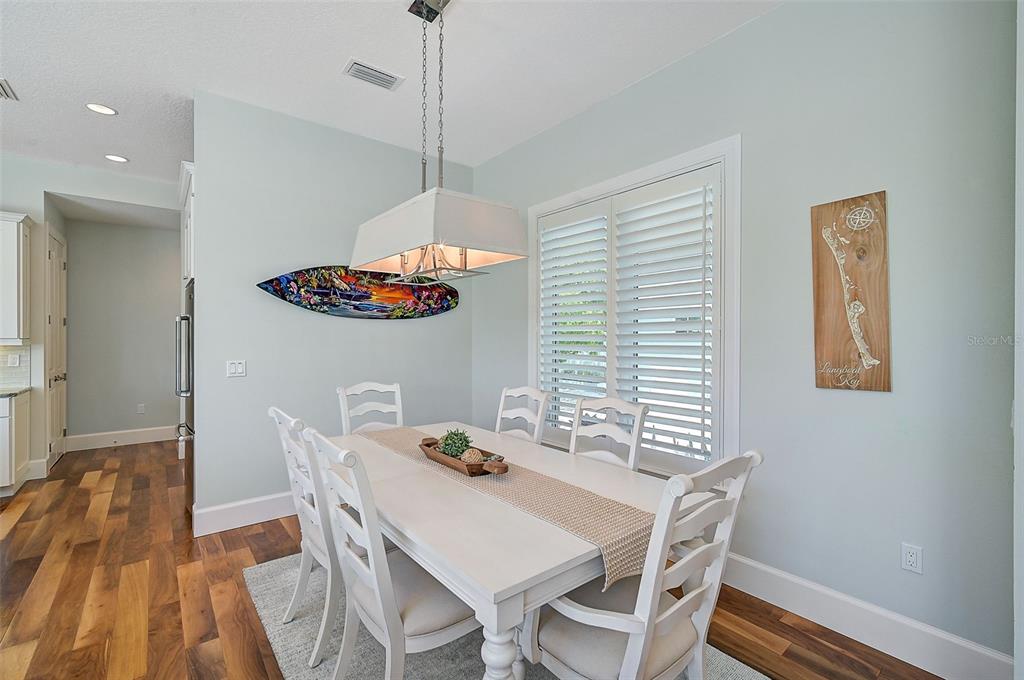 830 Tarawitt Drive Longboat Key, FL 34228 - Photo 7 of 74 a view of a dining room with furniture window and wooden floor
