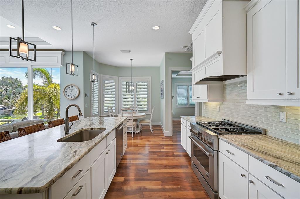 830 Tarawitt Drive Longboat Key, FL 34228 - Photo 9 of 74 a kitchen with granite countertop a sink a counter space appliances and cabinets