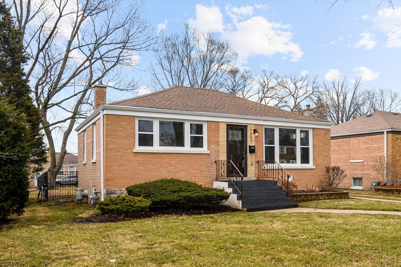 1507 North Taft Avenue Berkeley, IL 60163 - Photo 3 of 28 a front view of a house with garden and trees