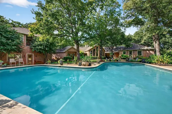 a view of swimming pool and deck in the backyard