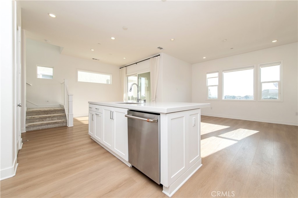 423 Flycatcher Irvine, CA 92618 - Photo 12 of 35 a kitchen with stainless steel appliances granite countertop a stove and a sink