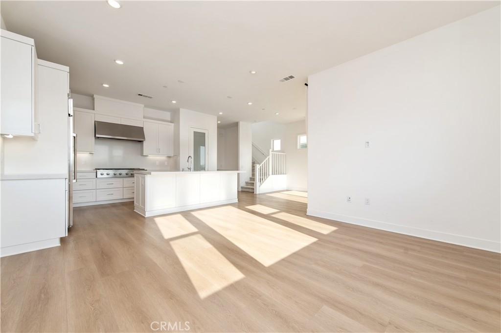 423 Flycatcher Irvine, CA 92618 - Photo 14 of 35 a large white kitchen with a refrigerator a stove and a sink