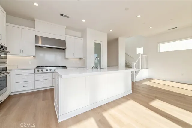 a kitchen with stainless steel appliances white cabinets and a granite counter tops
