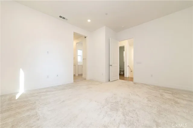 a spacious bathroom with a double vanity sink a mirror and a shower