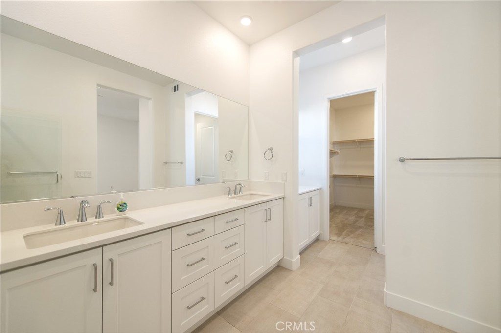 423 Flycatcher Irvine, CA 92618 - Photo 23 of 35 a spacious bathroom with a double vanity sink a mirror and a shower