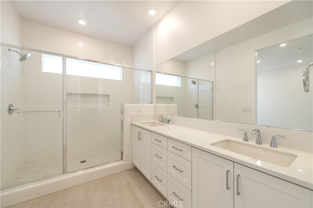 423 Flycatcher Irvine, CA 92618 - Photo 24 of 35 a bathroom with double sink and a mirror
