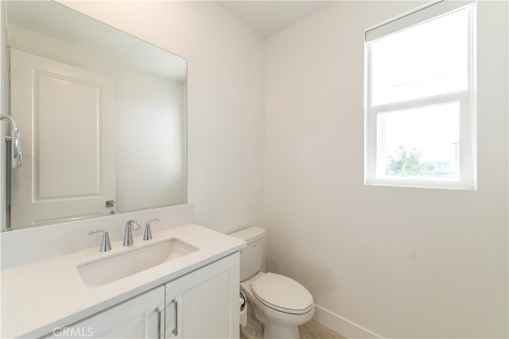 423 Flycatcher Irvine, CA 92618 - Photo 27 of 35 a bathroom with a toilet a sink a vanity and mirror