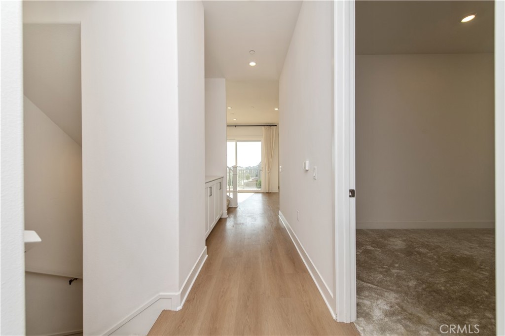 423 Flycatcher Irvine, CA 92618 - Photo 28 of 35 a view of a hallway with wooden floor