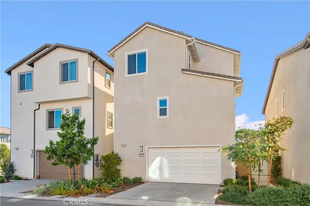 a front view of a house with plants