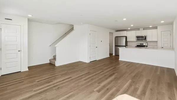 a view of a kitchen with a sink and a refrigerator