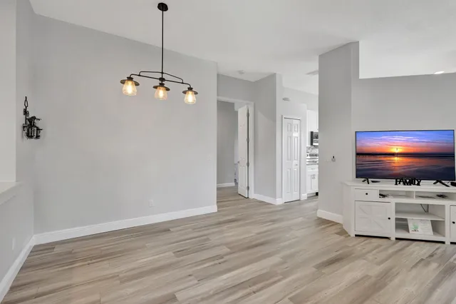 a view of a livingroom with furniture and flat screen tv