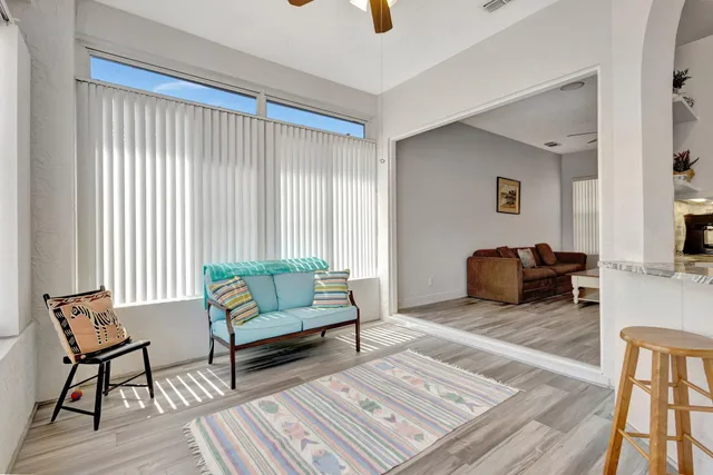a view of a patio with a table and chairs under an umbrella