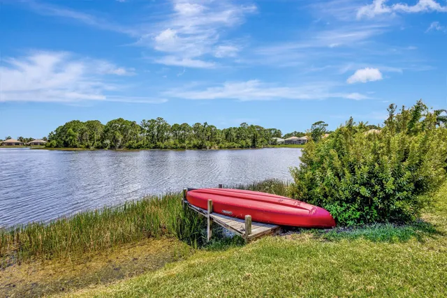 a swimming pool view with a seating space and a garden view