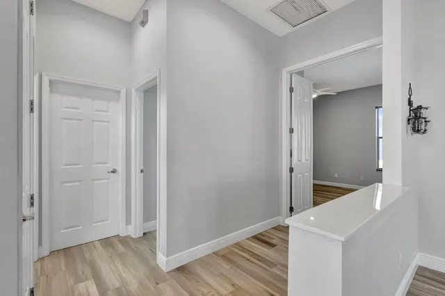 a view of room with window and wooden floor