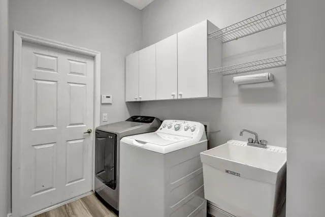 an aerial view of residential houses with outdoor space and lake view