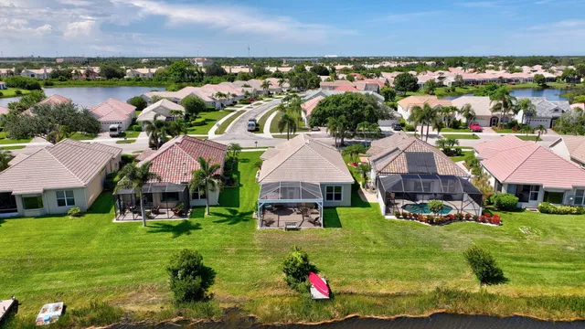 an aerial view of lake and residential houses with outdoor space