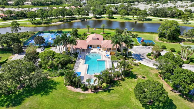 an aerial view of a house with a yard and lake view