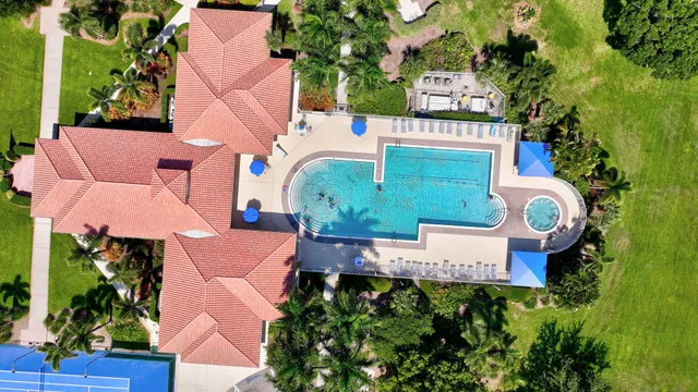 an aerial view of a house with swimming pool and garden