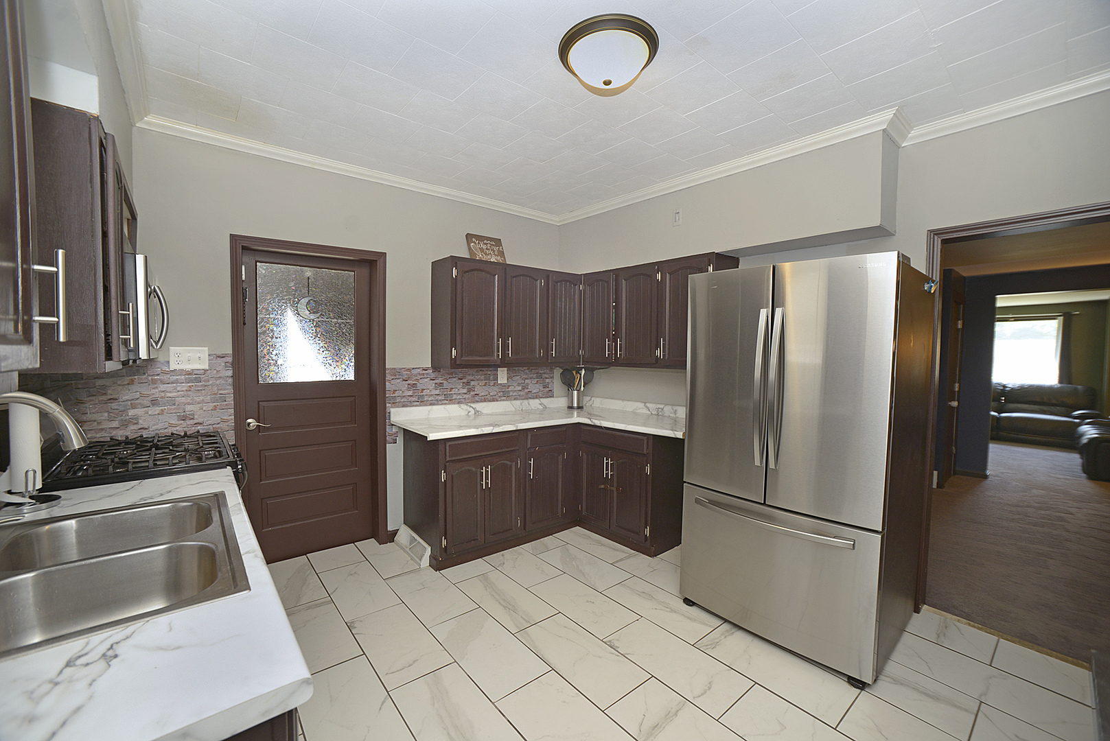 454 Washington Street Marseilles, IL 61341 - Photo 2 of 16 a kitchen with a refrigerator sink and cabinets