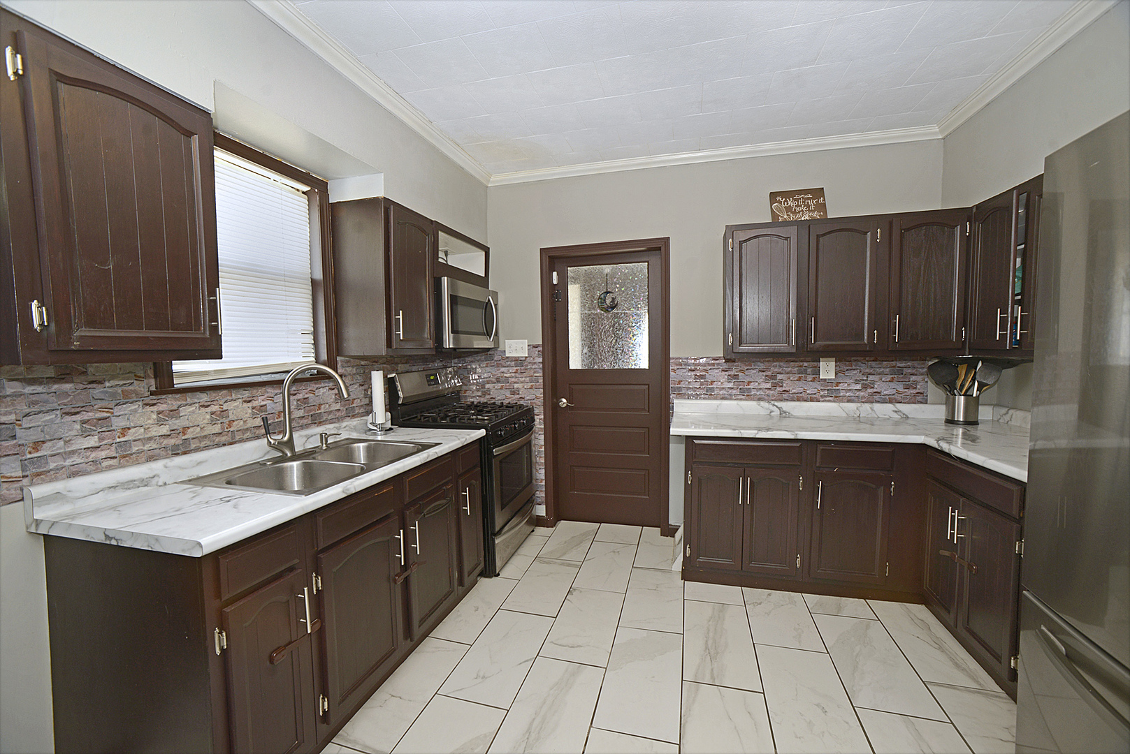 454 Washington Street Marseilles, IL 61341 - Photo 3 of 16 a kitchen with a sink stove and cabinets